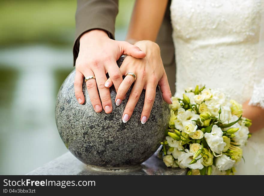 Bride and groom with flowers and wedding rings. Bride and groom with flowers and wedding rings