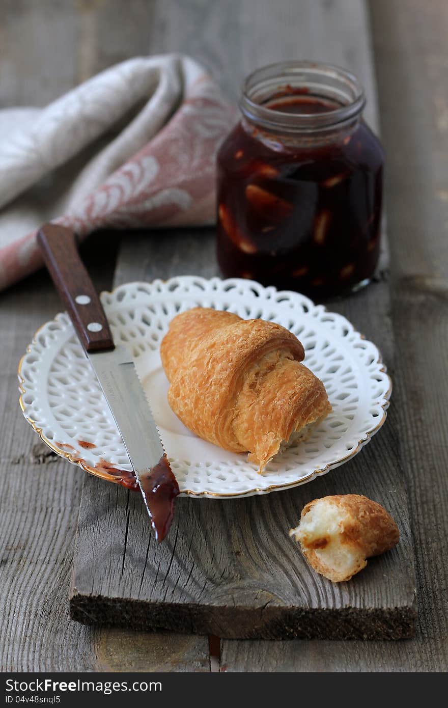 Croissant with jam for breakfast