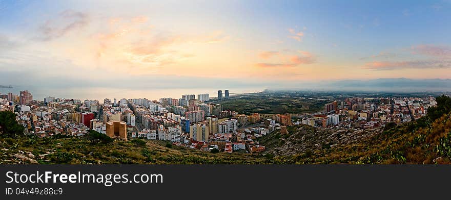 Panoramic view on a small spanish city Cullera (Valencia, Spain) at sunrise. Panoramic view on a small spanish city Cullera (Valencia, Spain) at sunrise