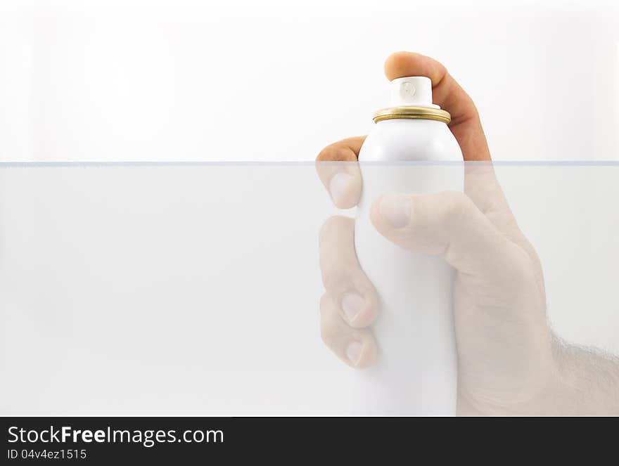 Hand holding spray can over white background. Hand holding spray can over white background