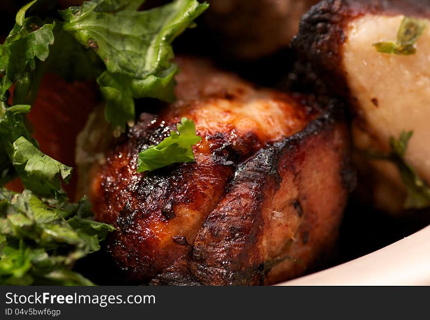 Portion of Perfect Ripe Pork Kebab closeup with Greens