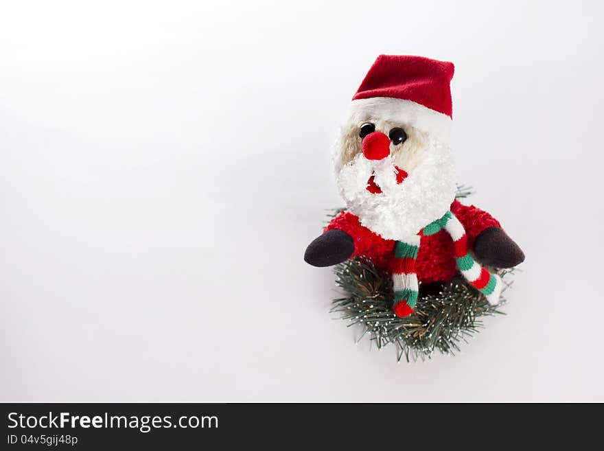 Little Toy Santa Claus in fir tree wreath