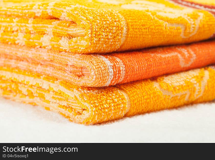 Orange and yellow Towels over white white