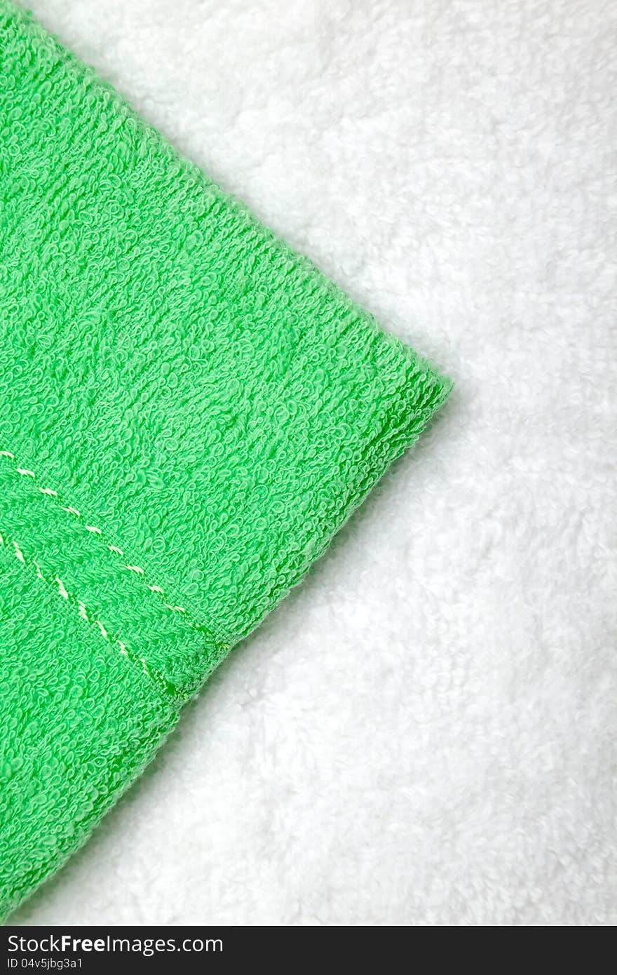 Green small towel or napkin over white. Green small towel or napkin over white