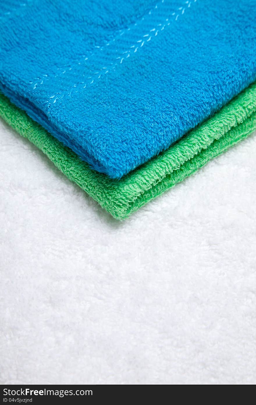 Stacked colorful towels isolates over white. Stacked colorful towels isolates over white