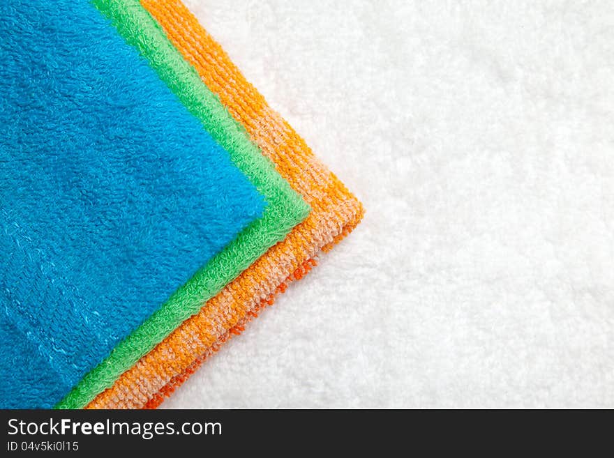 Stacked colorful towels isolates over white. Stacked colorful towels isolates over white