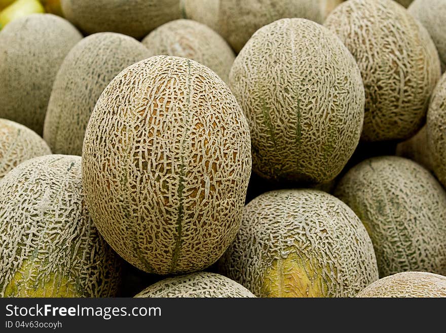 Piles of Rock melon display in market.