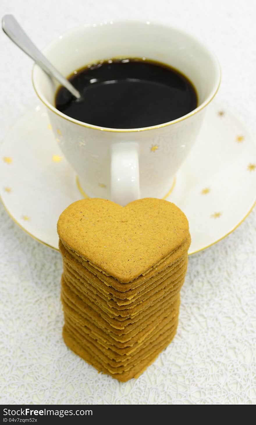 Big cup of black coffee and pile of gingerbreads. Big cup of black coffee and pile of gingerbreads