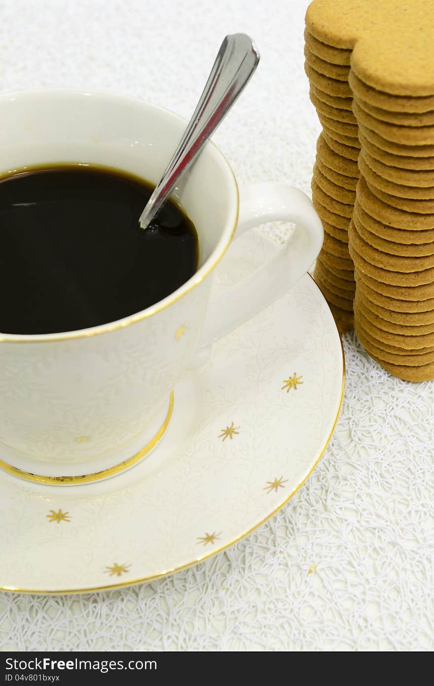 Big cup of black coffee and pile of gingerbreads. Big cup of black coffee and pile of gingerbreads