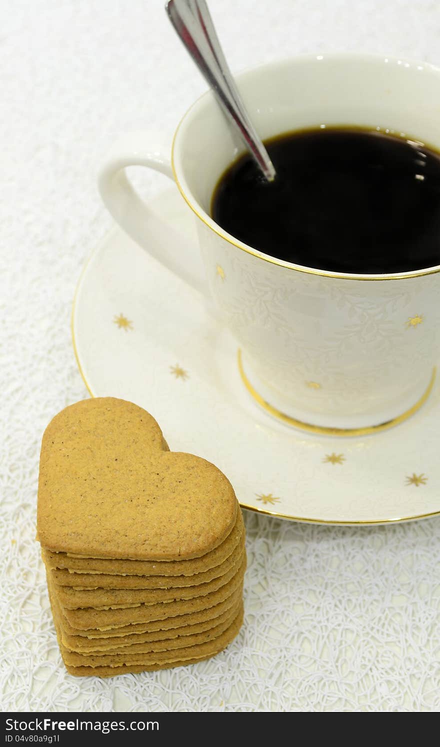 Big cup of black coffee and pile of gingerbreads. Big cup of black coffee and pile of gingerbreads