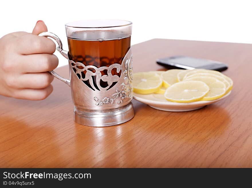 Hot aromatic tea with lemons on the table