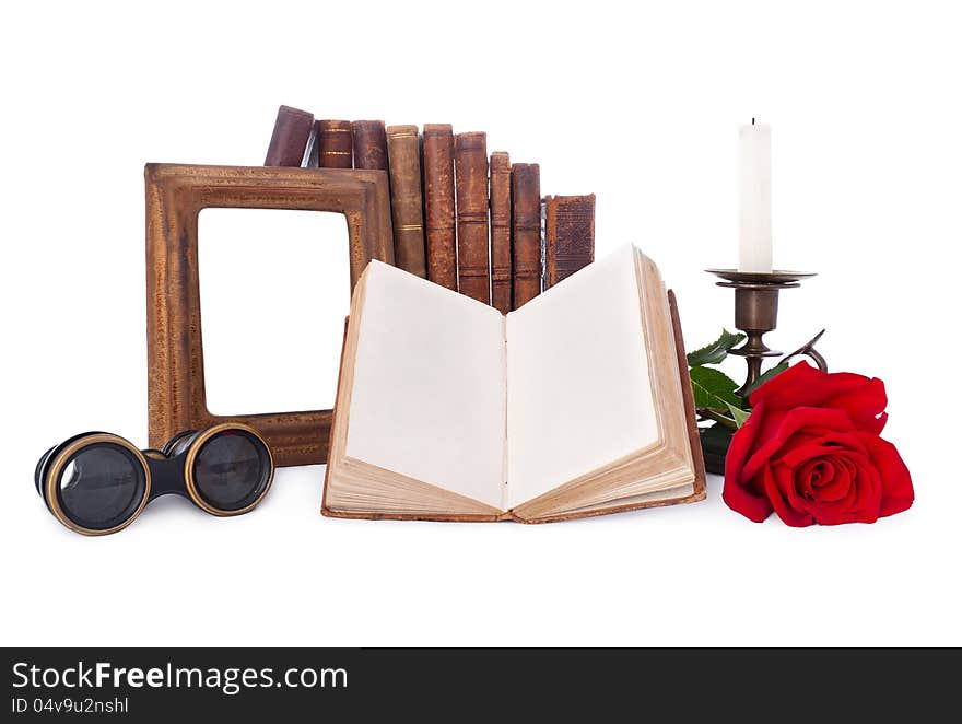 Still life with antique books and picture frames.