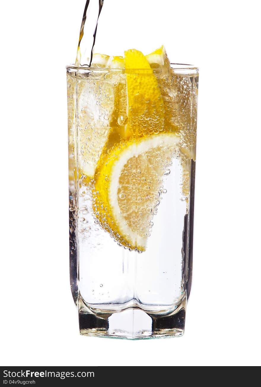 Full glass of water with lemon isolated on white background