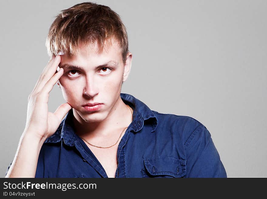 Young man holding hands on his head