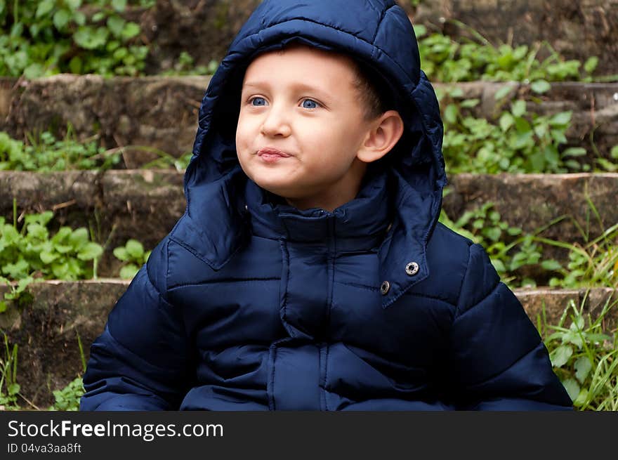 Little boy with thoughtful look outdoors. Little boy with thoughtful look outdoors