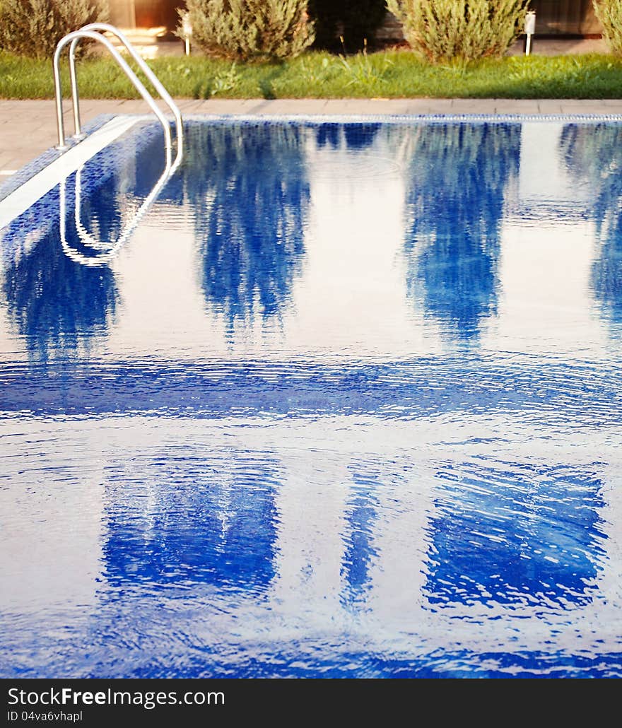 Swimming pool with stair at hotel close up