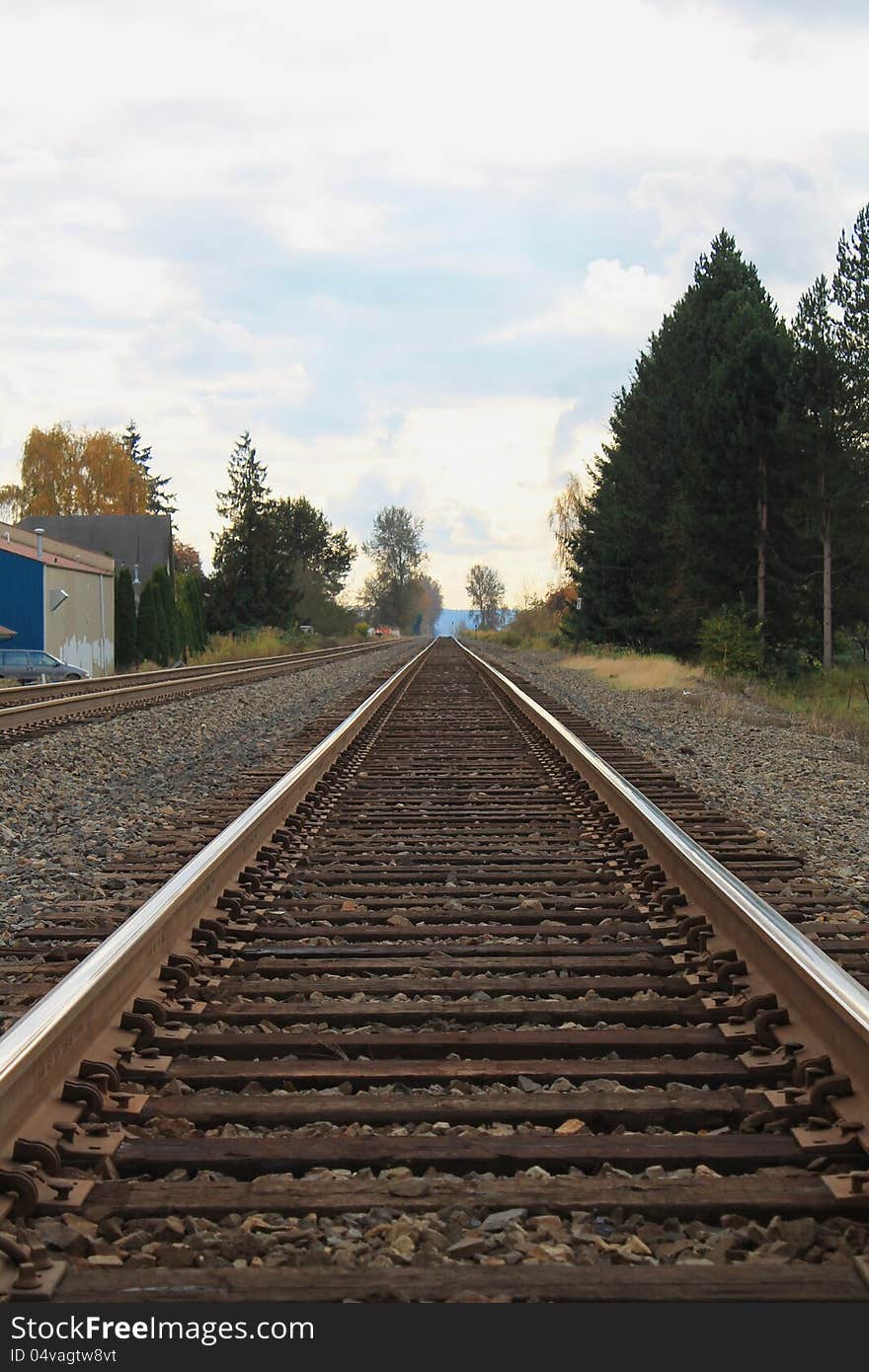 Railroad tracks heading out of a rural small town. Railroad tracks heading out of a rural small town