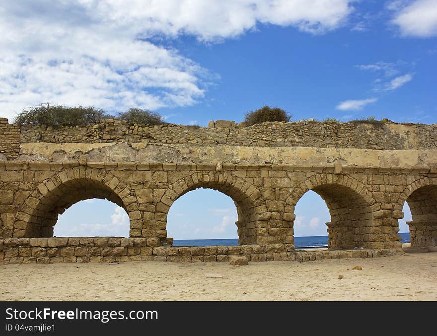 Stone arches of ancient Roman aqueduct at Caesarea along the coast of the Mediterranean Sea, Israel.