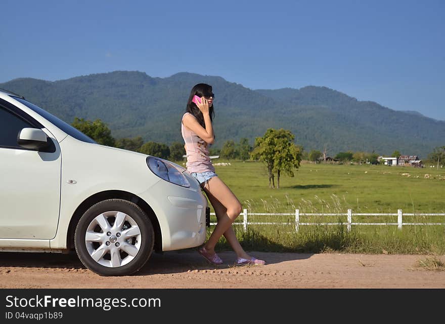 Pretty women use her phone in the country