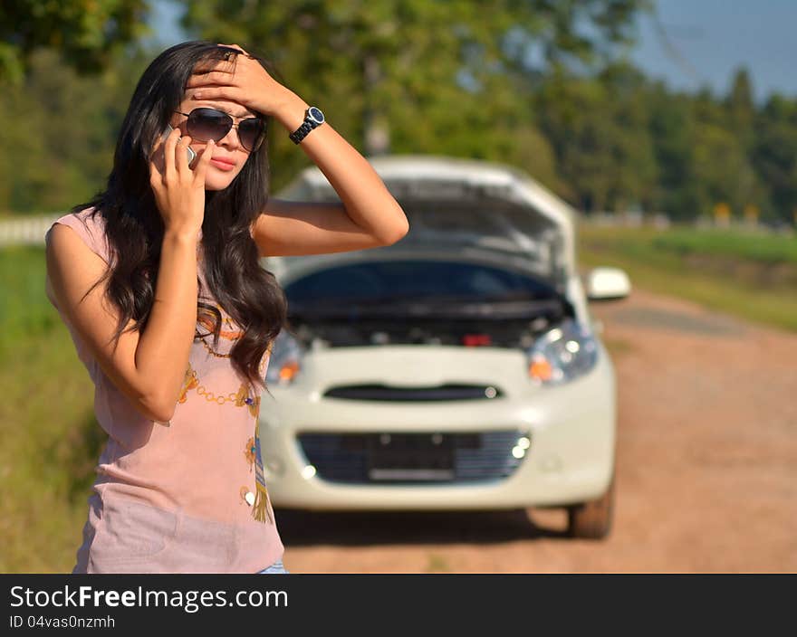 A woman calls for assistance after her car broke down