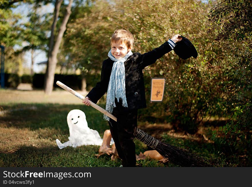 The nature boy in black hat and coat celebrates Halloween