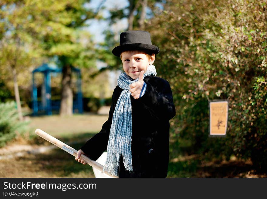 The nature boy in black hat and coat celebrates Halloween