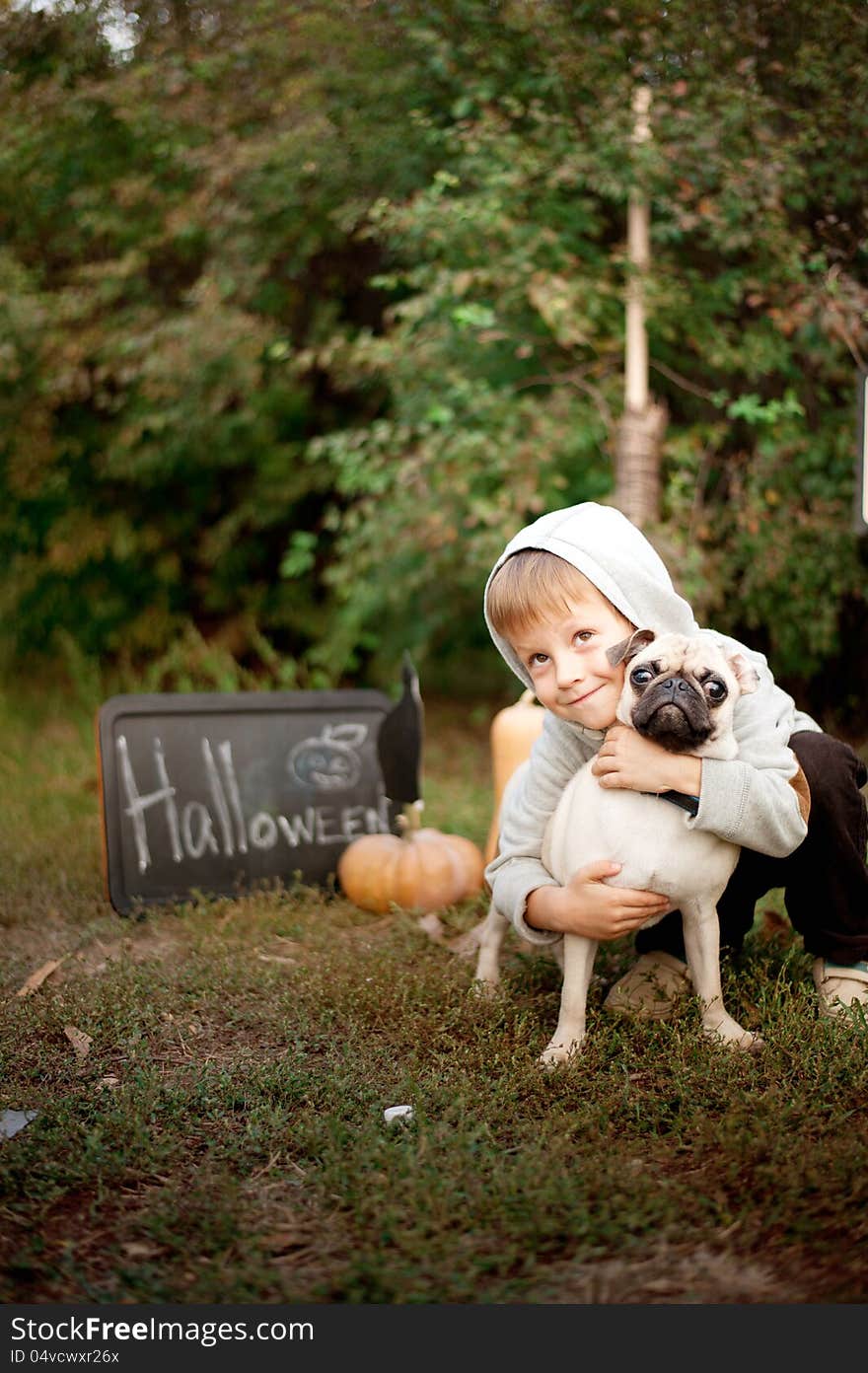 The nature boy hugs his beloved dog breed pug. The nature boy hugs his beloved dog breed pug