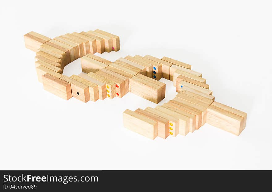 Symbol of dollar from wooden domino on white background. Symbol of dollar from wooden domino on white background