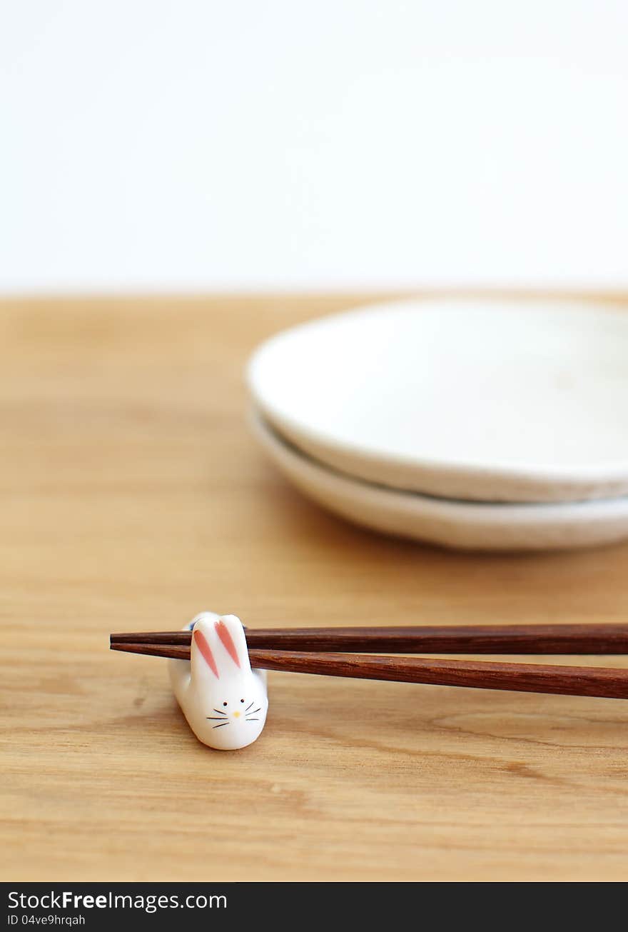 Chopsticks with asian set table on white background