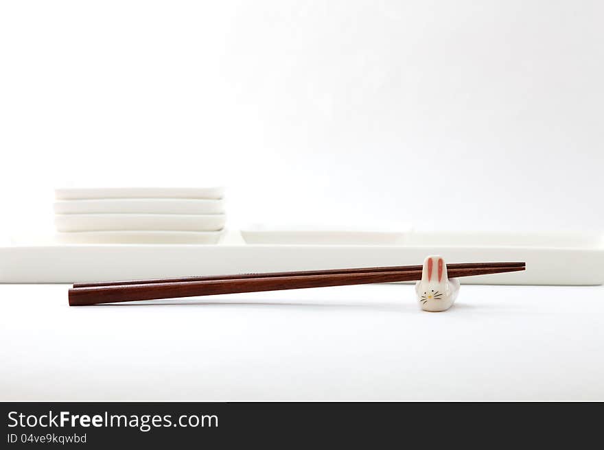 Chopsticks with asian set table on white background