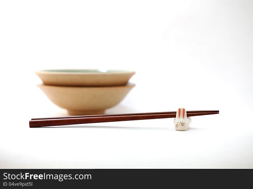 Chopsticks with asian set table on white background