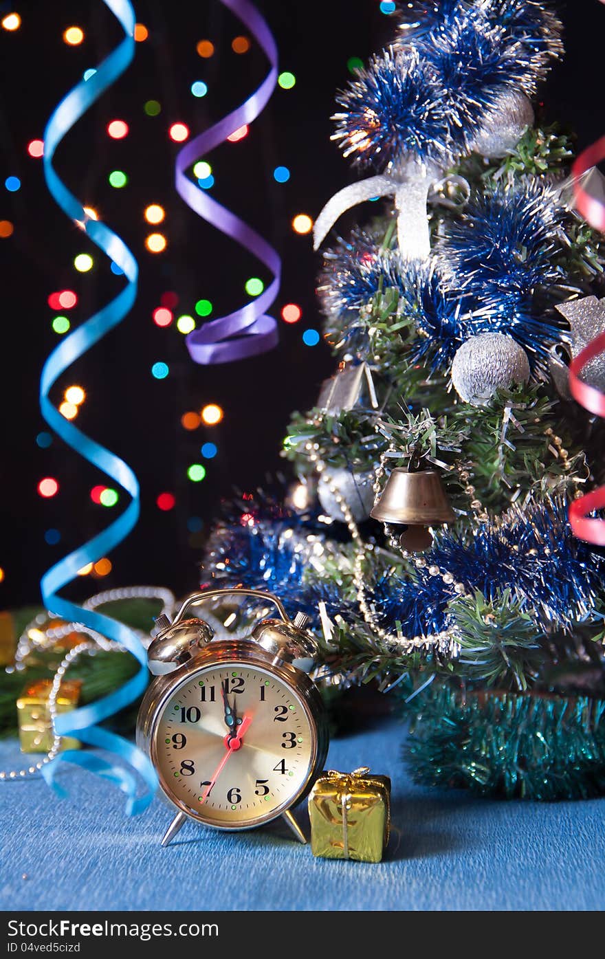 Clock,ball,the serpentine,a new year tree on a black background with lights. Clock,ball,the serpentine,a new year tree on a black background with lights