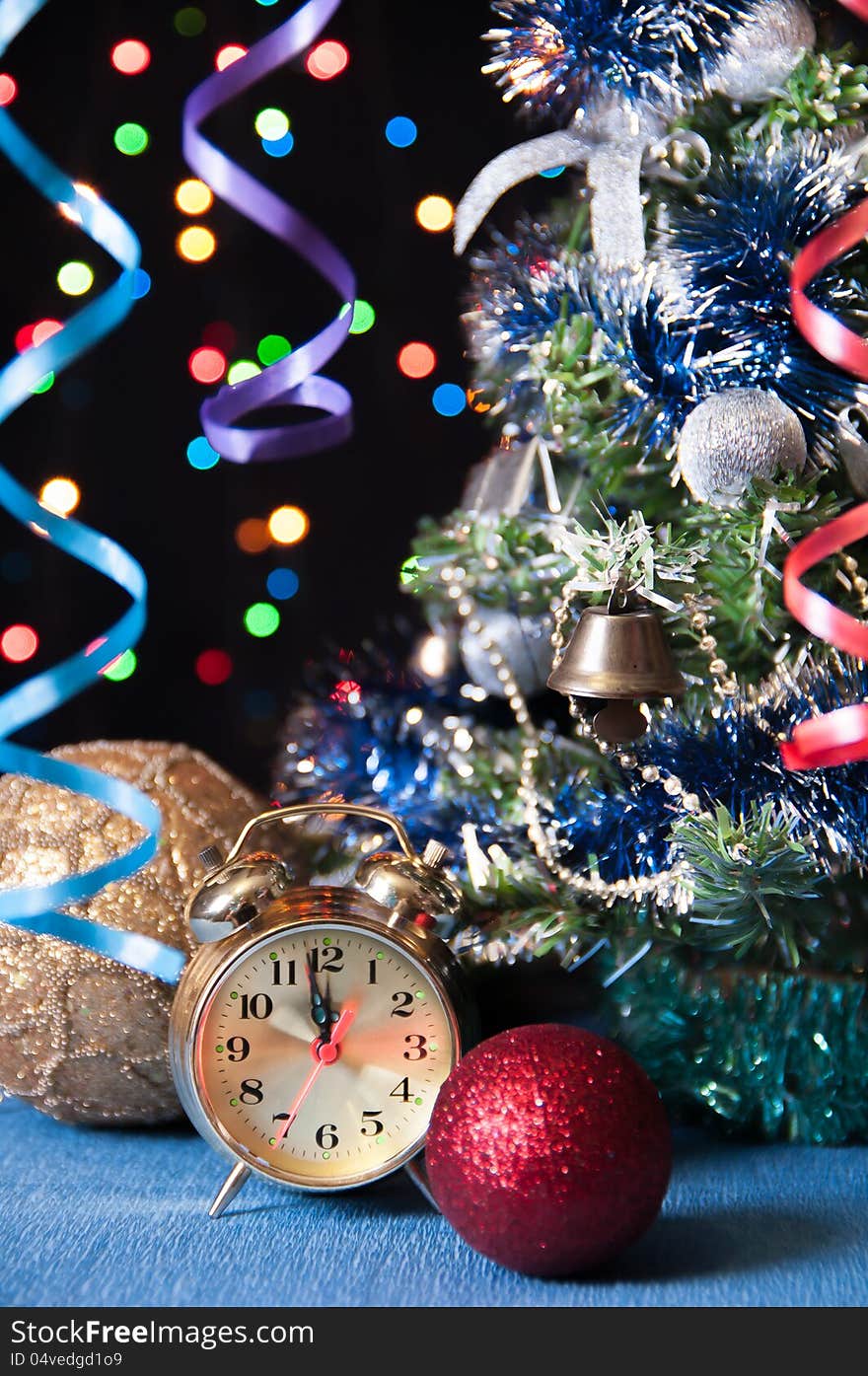 Clock,ball,the serpentine,a new year's tree on a black background with lights. Clock,ball,the serpentine,a new year's tree on a black background with lights