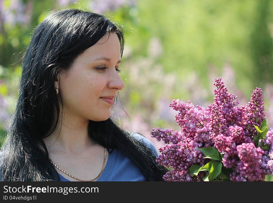 young woman with syringa bouquet