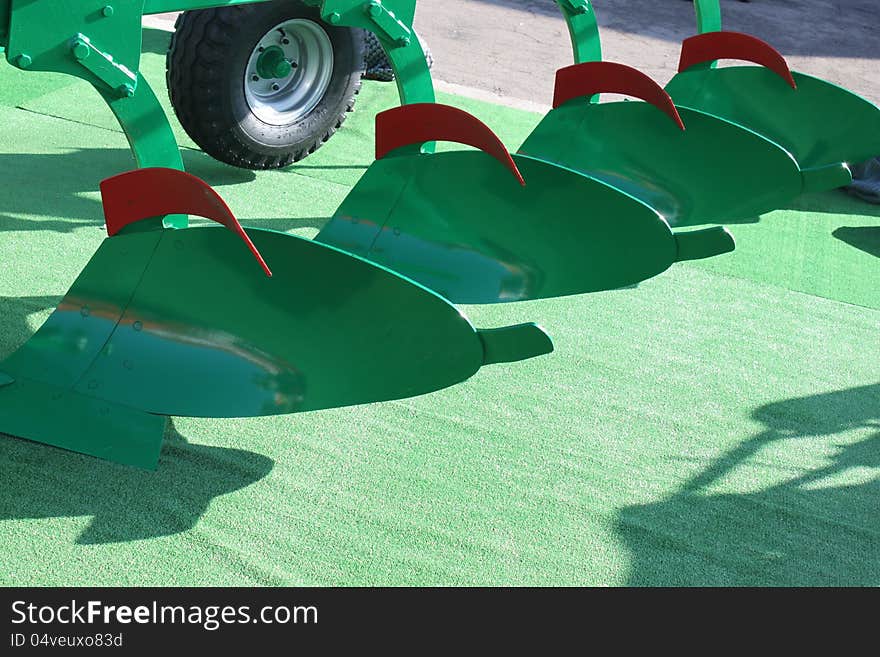 Detail of agricultural machinery on green background