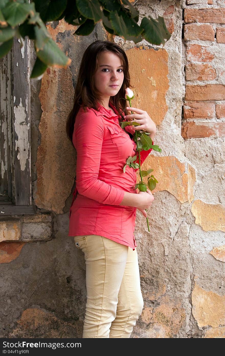 Beautiful young girl against a wall. Beautiful young girl against a wall