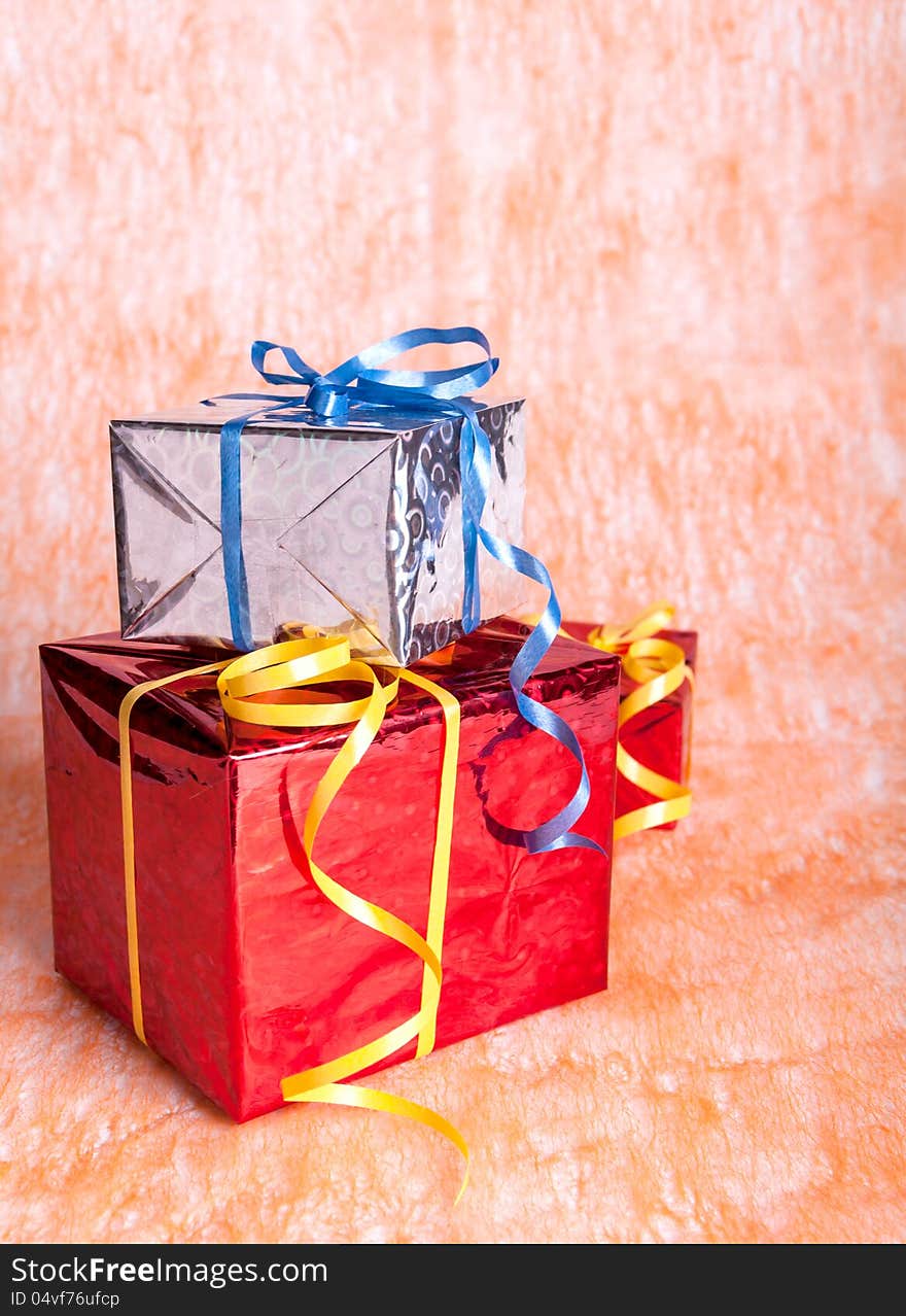 Three gift boxes on an orange background