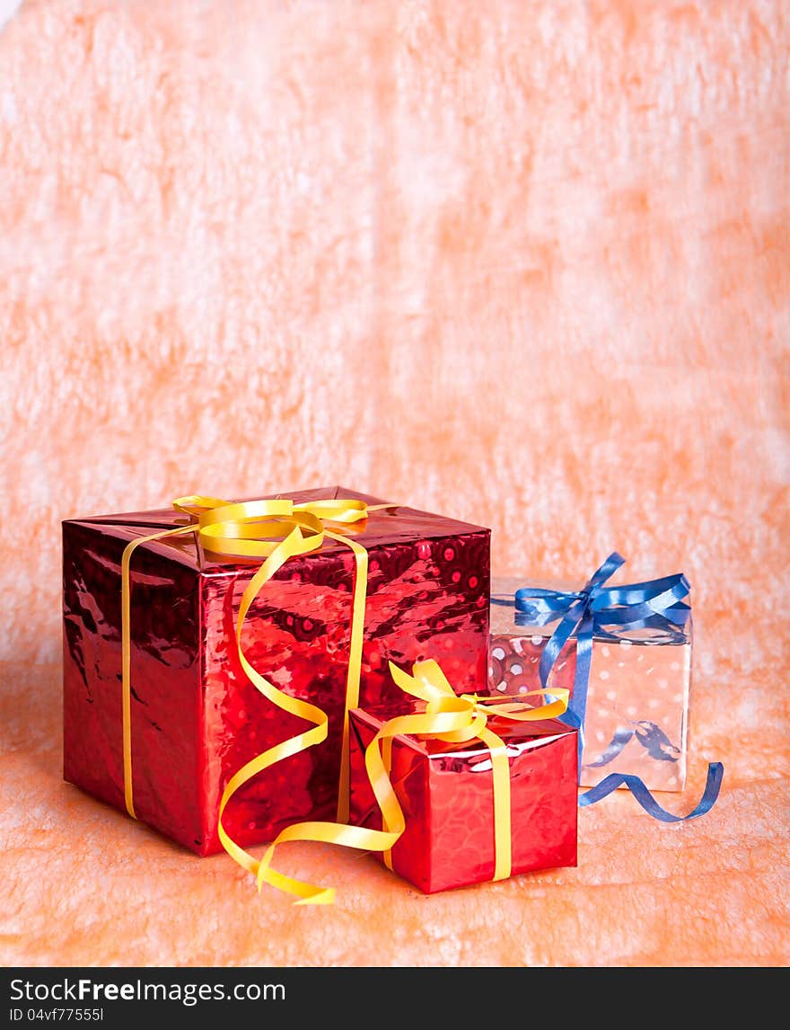 Three gift boxes on an orange background