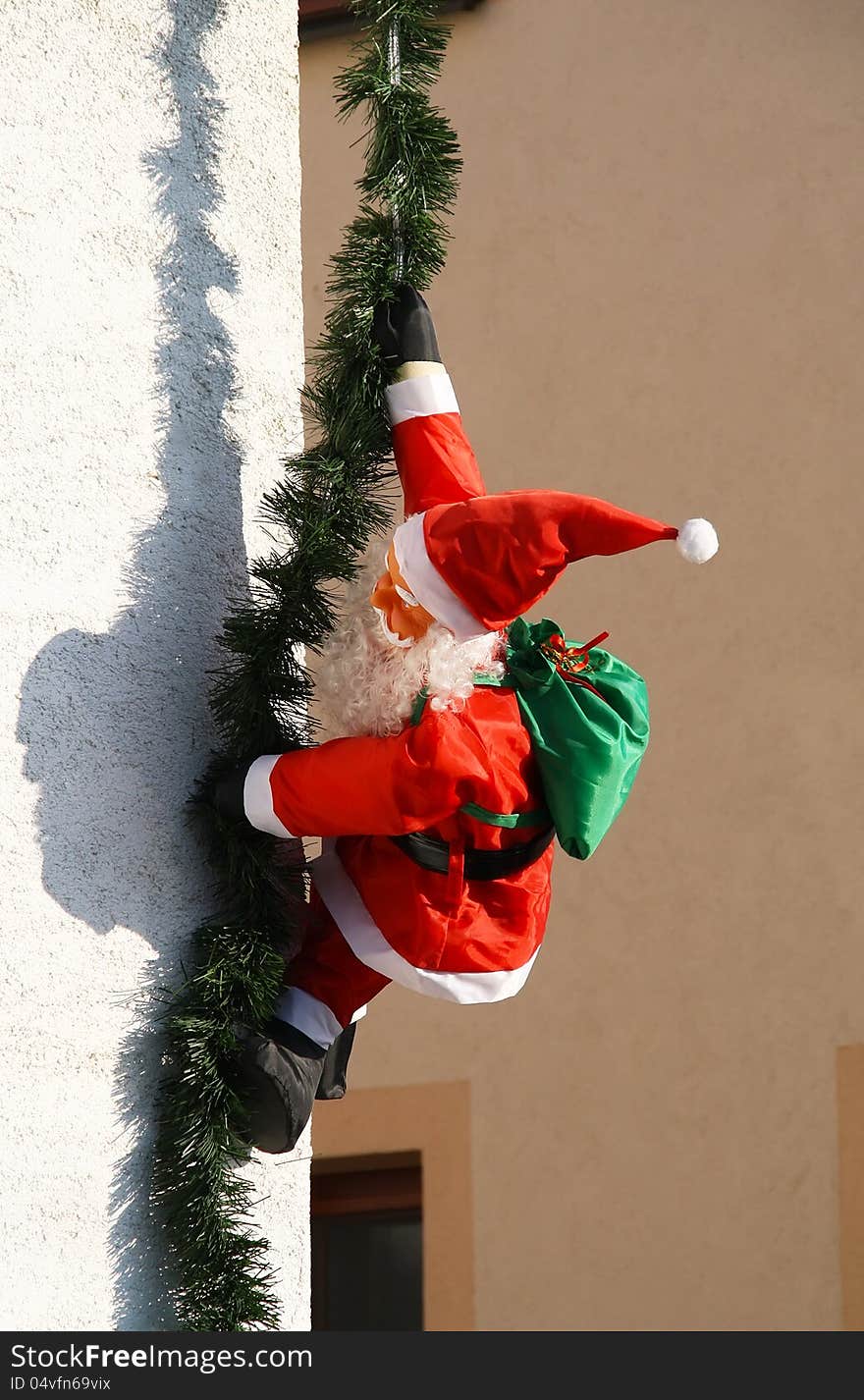 Santa claus (or St. Nicholaus) distributes gifts through the window. A funny concept.