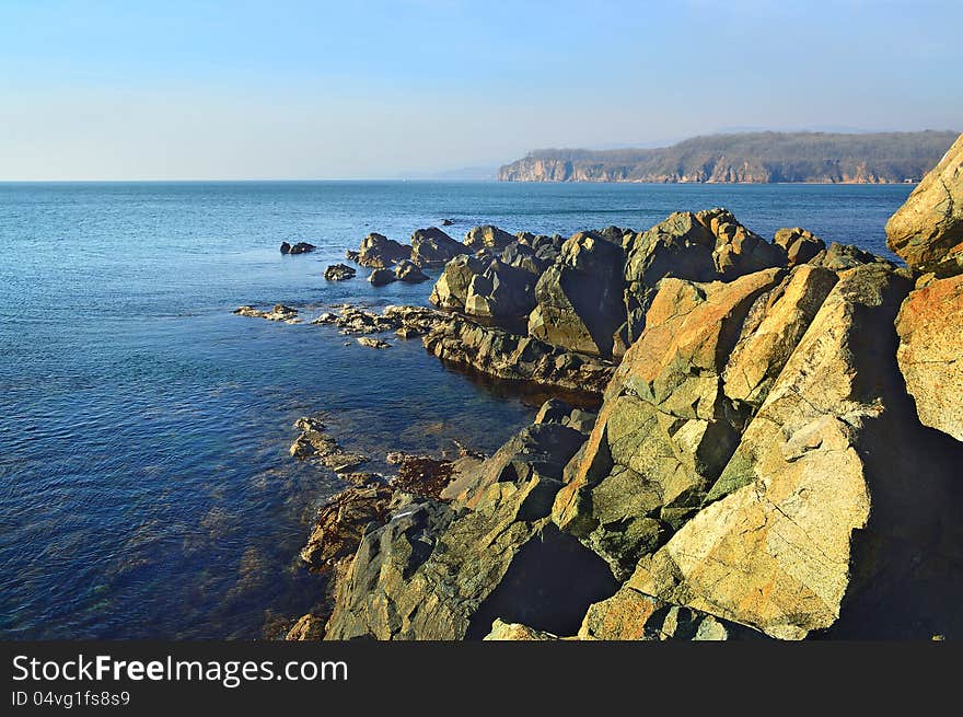 The line of rocks going away in the depth of the sea. The line of rocks going away in the depth of the sea