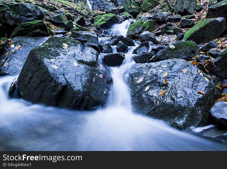 Forest stream in mountains running over mossy rocks. Forest stream in mountains running over mossy rocks