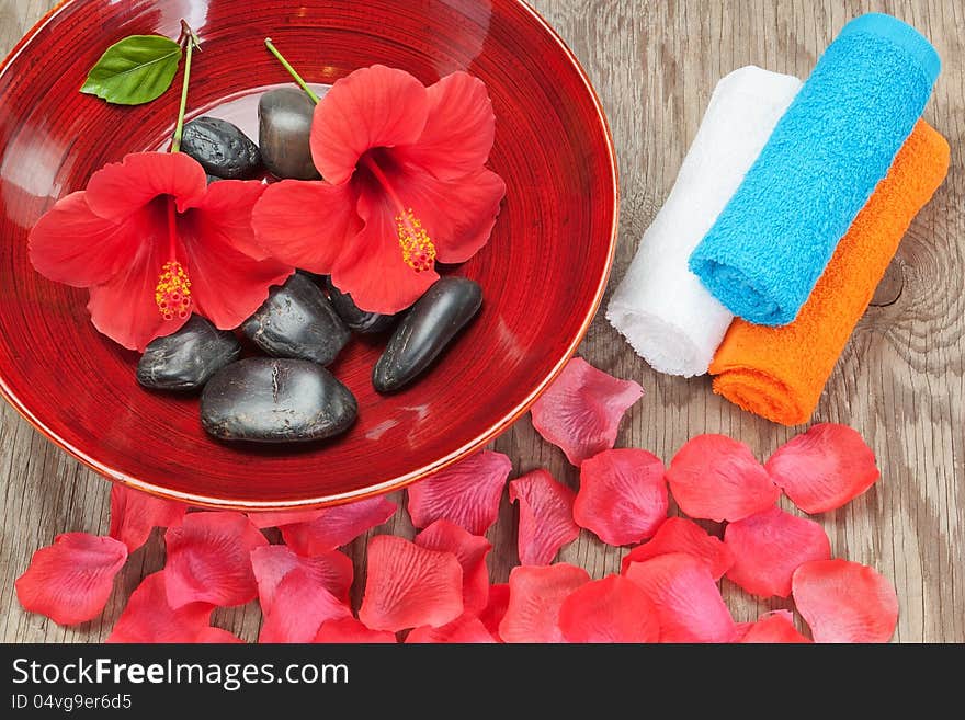 Spa arrangement of flower petals. On a wooden tecture.