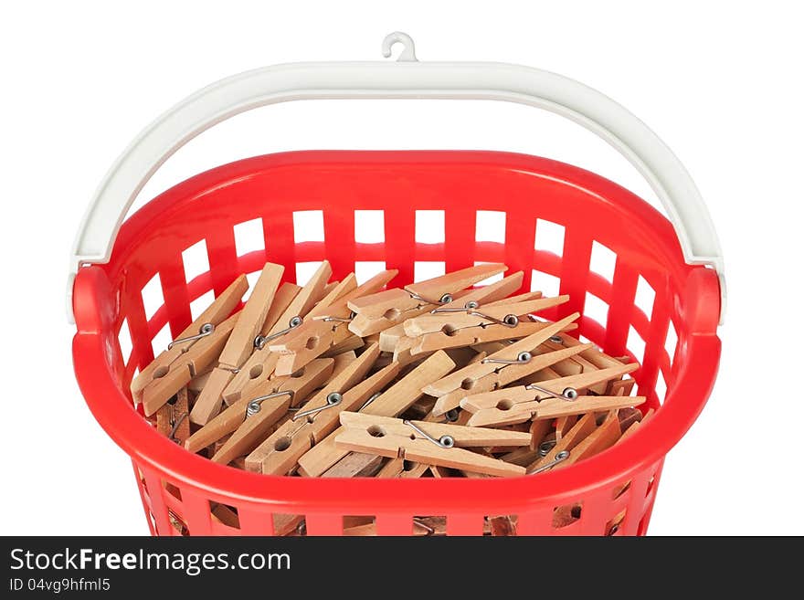 Set of clothespins in the red basket. Closeup.