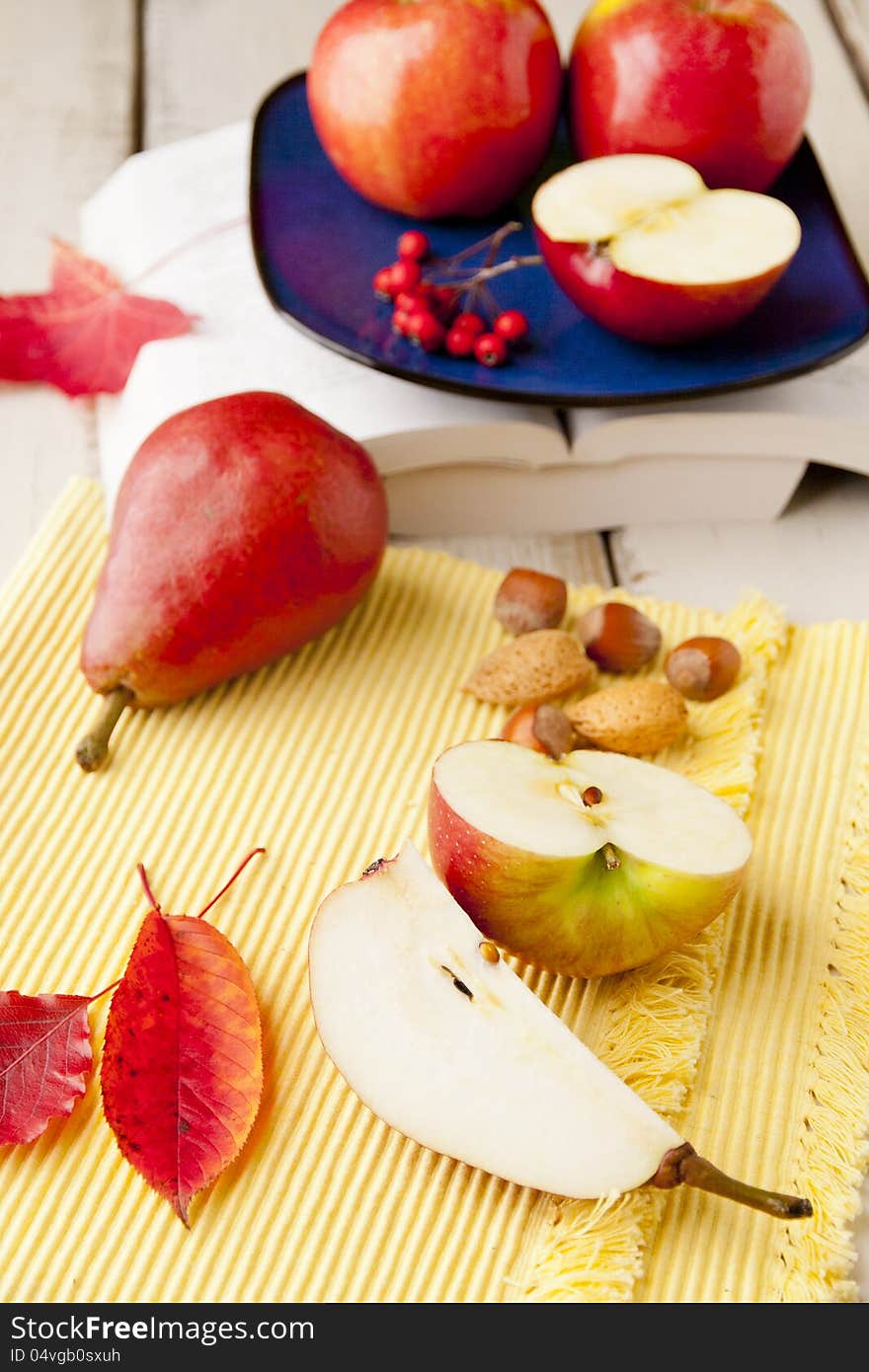 Apples and pears on wood table. shallow dof