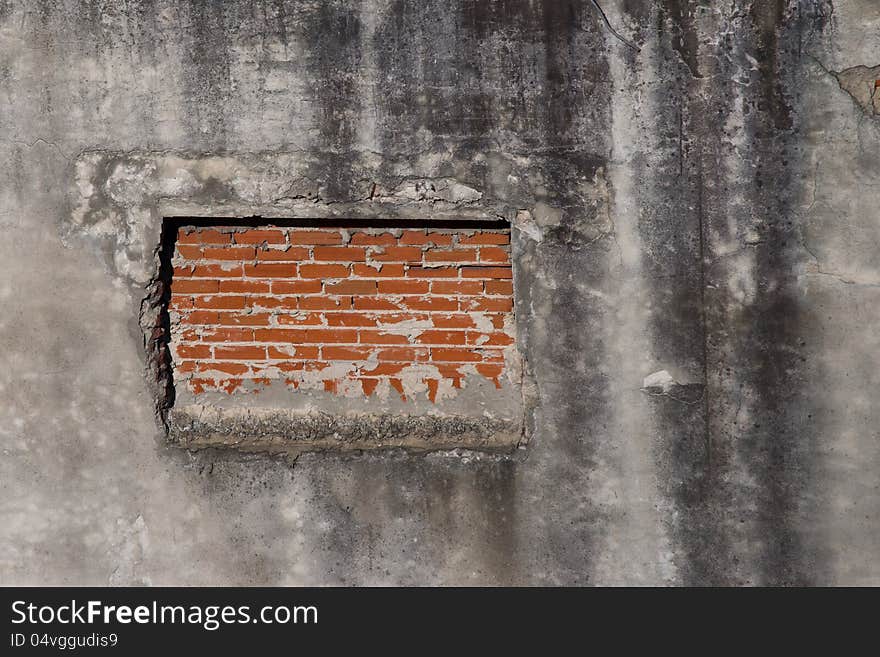 Window blocked by brick wall, abandoned building