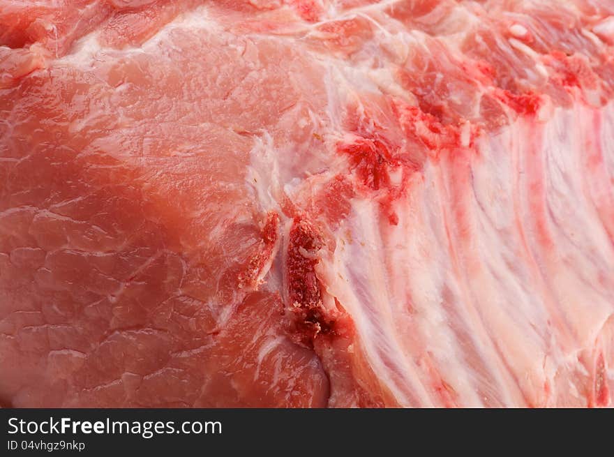 Background of Perfect Raw Pork Chop with Ribs closeup