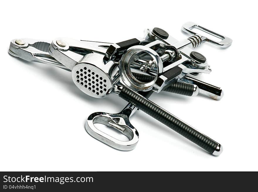 Heap of Kitchen Tools with Corkscrew, Garlic Press, Nutcracker and Opener on white background