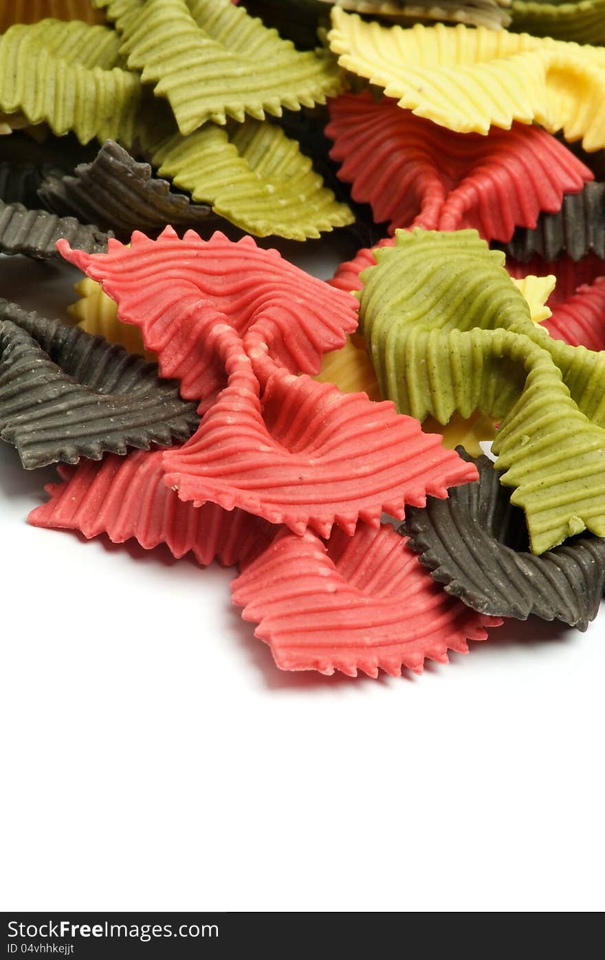 Raw Pasta Three Color Farfalle closeup on white background