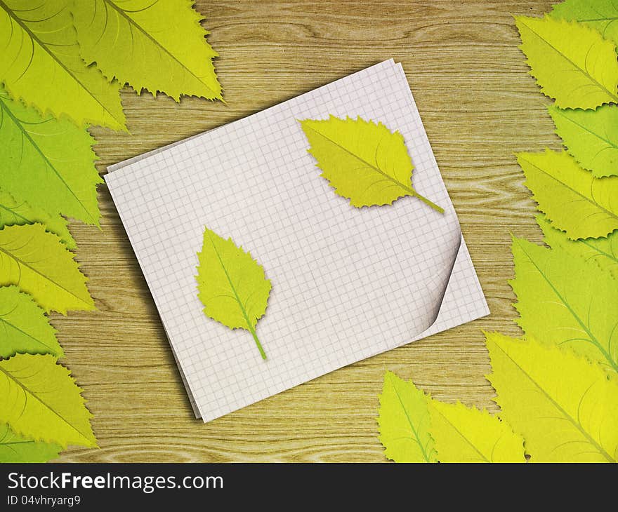 Green leaves over wooden background