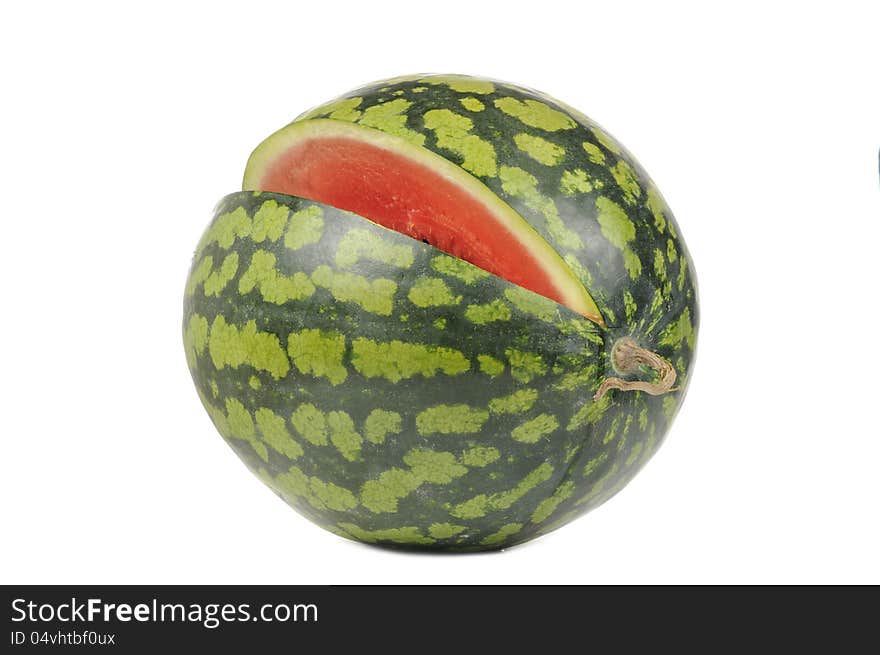 A watermelon with a missing slice isolated on a white background. A watermelon with a missing slice isolated on a white background